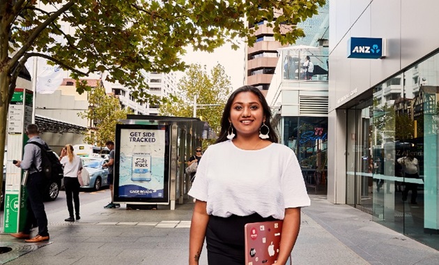 Female student standing in the middle of St Georges Terrace in Perth